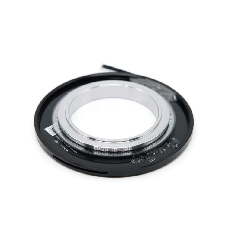 Close-up of a camera lens with focus ring and aperture control for photography.